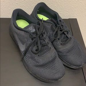 All black sleek Nike tennis shoes